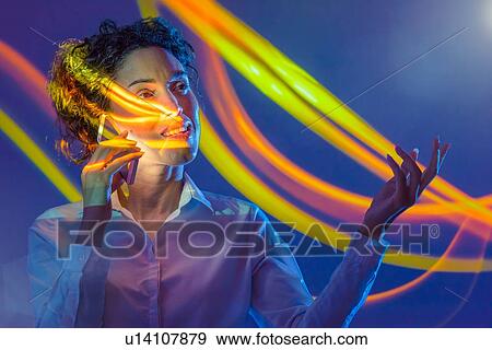 Woman using smart phone with projection View Large Photo Image Stock Photo - Woman using smart phone with projection. Fotosearch