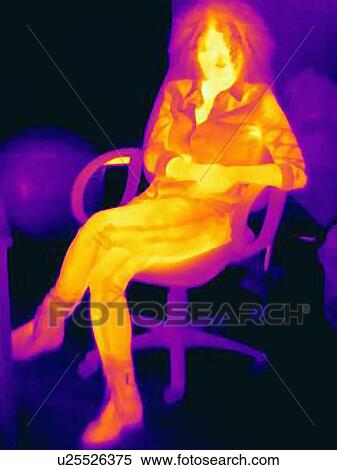 Stock Photography - Woman with curly hair on chair, thermal image. Fotosearch