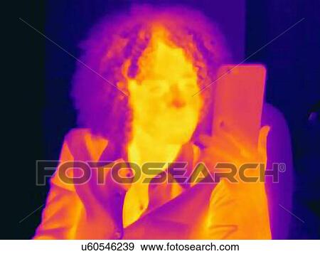 Woman with curly hair using smartphone, thermal image View Large Photo Image Stock Photo - Woman with curly hair using smartphone, thermal image. Fotosearch