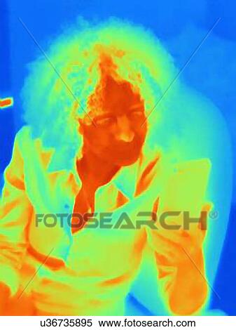 Woman with curly hair using smartphone, thermal image View Large Photo Image Stock Photography - Woman with curly hair using smartphone, thermal image. Fotosearch