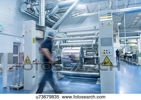 Worker unloading printed roll in food packaging printing factory View Large Photo Image Stock Photography - Worker unloading printed roll in food packaging printing factory. Fotosearch