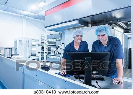 Workers at computer station in food packaging printing factory View Large Photo Image Stock Image - Workers at computer station in food packaging printing factory. Fotosearch