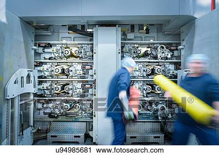 Workers loading printing plates into printer in food packaging printing factory View Large Photo Image Stock Image - Workers loading printing plates into printer in food packaging printing factory. Fotosearch