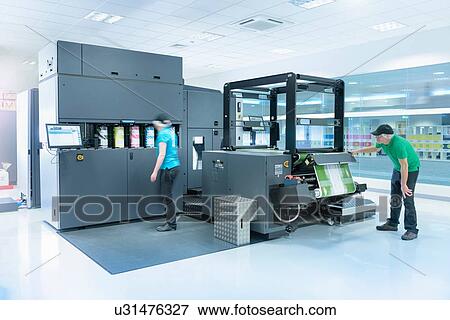 Workers with ink jet printer in food packaging printing factory View Large Photo Image Stock Photo - Workers with ink jet printer in food packaging printing factory. Fotosearch