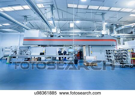 Workers with printing machine in food packaging printing factory View Large Photo Image Stock Photography - Workers with printing machine in food packaging printing factory. Fotosearch