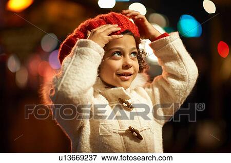 Young girl, outdoors at night, wearing coat and red beret View Large Photo Image Stock Photo - Young girl, outdoors at night, wearing coat and red beret. Fotosearch