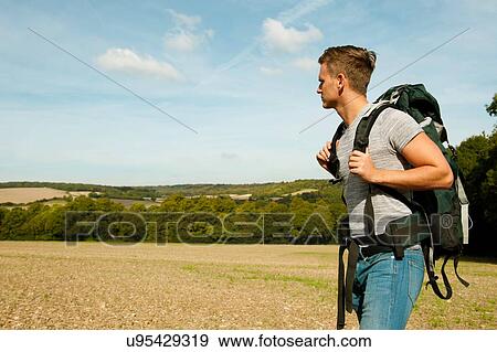 Stock Photo - Young male hiker in field landscape, Great Missenden, Buckinghamshire, U. K. Fotosearch