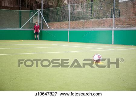Young man on urban football pitch View Large Photo Image Stock Photo - Young man on urban football pitch. Fotosearch