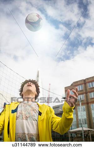 Stock Photo - Young man practising football skills. Fotosearch
