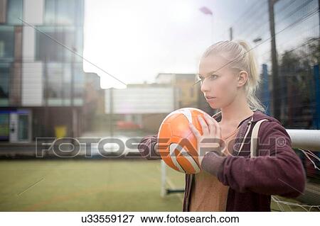 Young woman about to throw football View Large Photo Image Stock Photo - Young woman about to throw football. Fotosearch