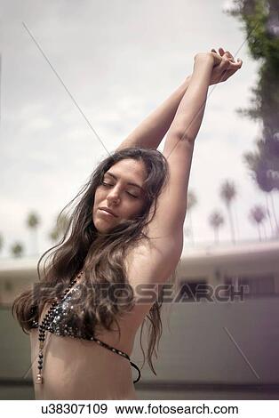 Young woman in bikini enjoying fresh air View Large Photo Image Stock Photo - Young woman in bikini enjoying fresh air. Fotosearch