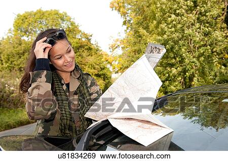 Stock Photo - Young woman looking at map. Fotosearch