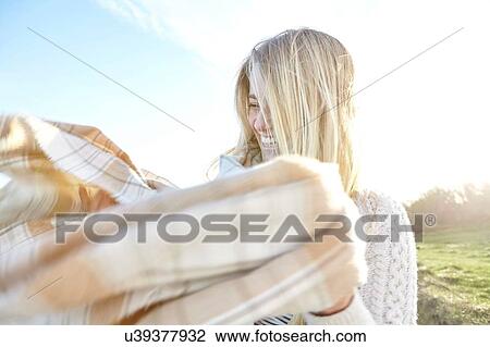 Young woman struggling with wind blown scarf View Large Photo Image Stock Image - Young woman struggling with wind blown scarf. Fotosearch