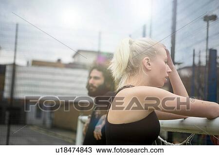 Young woman taking a break, leaning on football goal View Large Photo Image Stock Image - Young woman taking a break, leaning on football goal. Fotosearch