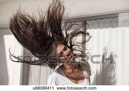 Young woman throwing hair back, in front of sliding doors View Large Photo Image Stock Image - Young woman throwing hair back, in front of sliding doors. Fotosearch