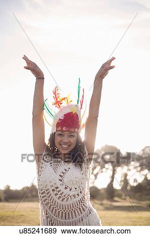 Young woman wearing feathered headdress View Large Photo Image Stock Photo - Young woman wearing feathered headdress. Fotosearch