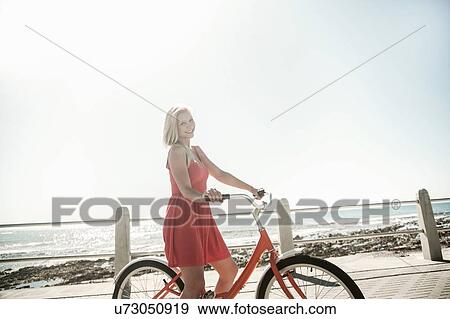 Young woman with bicycle on seafront, Cape Town, South Africa View Large Photo Image Stock Photo - Young woman with bicycle on seafront, Cape Town, South Africa. Fotosearch