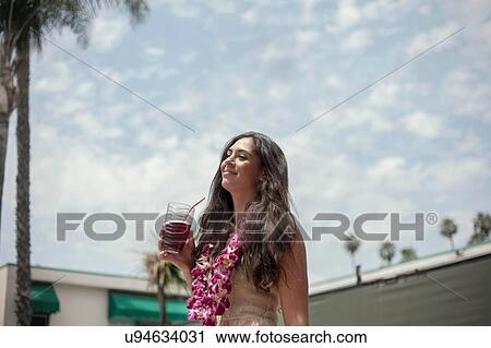 Young woman with glass of juice View Large Photo Image Stock Image - Young woman with glass of juice. Fotosearch
