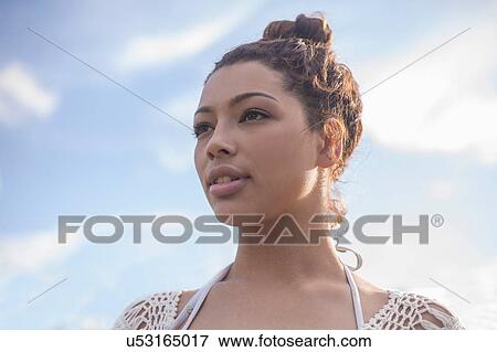 Young woman with hair bun View Large Photo Image Stock Photo - Young woman with hair bun. Fotosearch