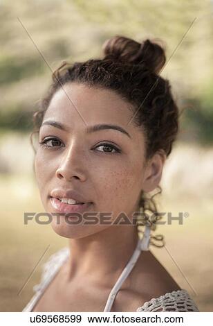 Stock Photo - Young woman with hair bun. Fotosearch