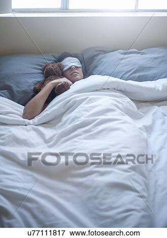 Young woman with teddy bear, sleeping in bed View Large Photo Image Stock Photo - Young woman with teddy bear, sleeping in bed. Fotosearch