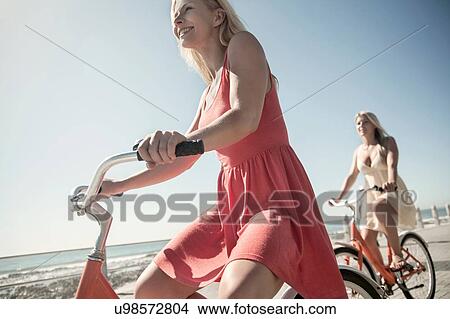 Young women cycling on seafront, Cape Town, South Africa View Large Photo Image Picture - Young women cycling on seafront, Cape Town, South Africa. Fotosearch