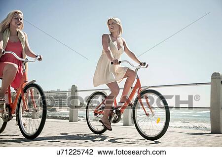 Young women cycling on seafront, Cape Town, South Africa View Large Photo Image Stock Image - Young women cycling on seafront, Cape Town, South Africa. Fotosearch