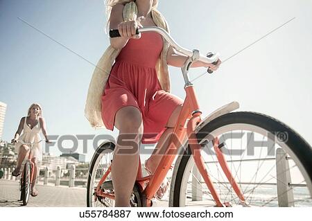 Young women cycling on seafront, Cape Town, South Africa View Large Photo Image Stock Photo - Young women cycling on seafront, Cape Town, South Africa. Fotosearch