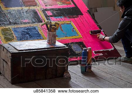 Stock Photo - Artist painting on canvas. Fotosearch
