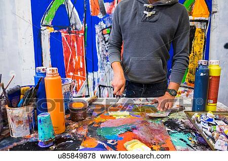 Stock Photo - Artist painting on canvas. Fotosearch