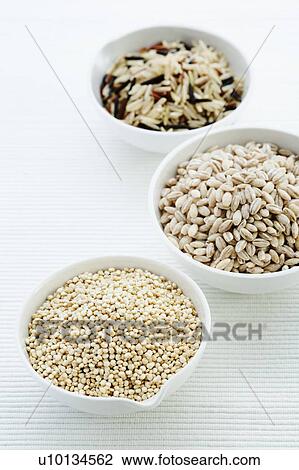 Stock Image - Barley, rice and quinoa in bowls. Fotosearch