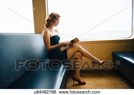 "Beautiful sophisticated woman reading magazine on ferry crossing, Seattle, USA" View Large Photo Image Stock Photograph - "Beautiful sophisticated woman reading magazine on ferry crossing, Seattle, USA". Fotosearch