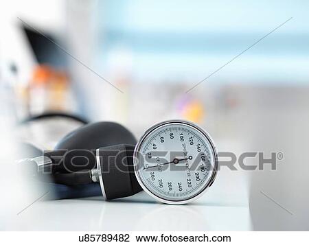 Stock Image - Blood pressure monitor on desk. Fotosearch