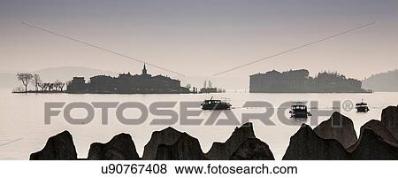Stock Photo - Boats and small islands, Lake Maggiore, Piedmont, Lombardy, Italy. Fotosearch
