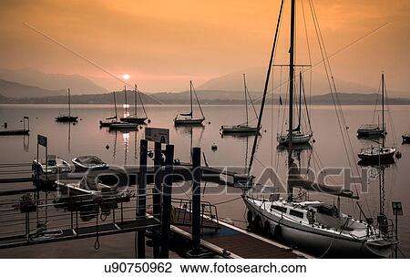 Stock Image - Boats in marina, Lake Maggiore, Piedmont, Lombardy, Italy. Fotosearch