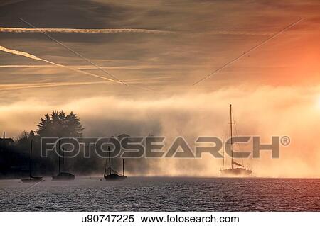 Boats in mist, Lake Maggiore, Piedmont, Lombardy, Italy View Large Photo Image Stock Photography - Boats in mist, Lake Maggiore, Piedmont, Lombardy, Italy. Fotosearch