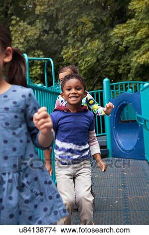 Boy and girls running on playground climbing frame View Large Photo Image Picture - Boy and girls running on playground climbing frame. Fotosearch