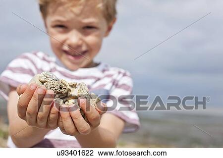 Boy collecting stones View Large Photo Image Stock Image - Boy collecting stones. Fotosearch
