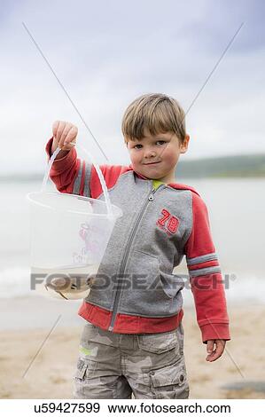 Boy holding crab View Large Photo Image Stock Photo - Boy holding crab. Fotosearch