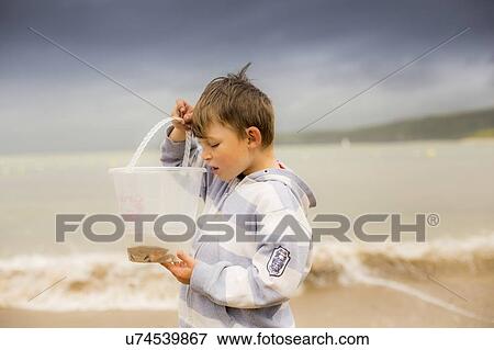 Boy holding crab View Large Photo Image Stock Photo - Boy holding crab. Fotosearch