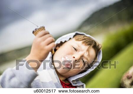 Stock Photo - Boy holding ice cream. Fotosearch