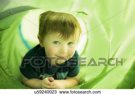 Boy in green tunnel View Large Photo Image Stock Image - Boy in green tunnel. Fotosearch
