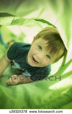 Boy in green tunnel View Large Photo Image Stock Photo - Boy in green tunnel. Fotosearch