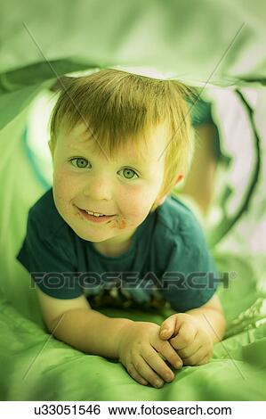 Stock Photograph - Boy in green tunnel. Fotosearch