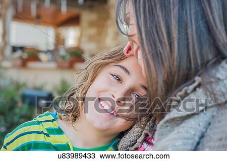 Stock Image - Boy leaning on mother's chest. Fotosearch