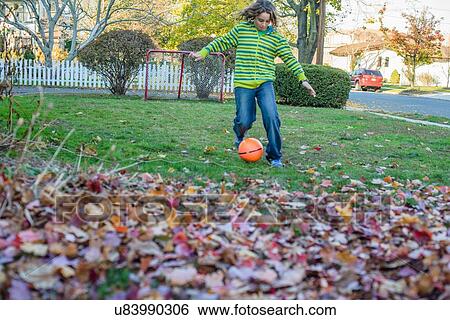 Boy playing ball in garden View Large Photo Image Stock Photograph - Boy playing ball in garden. Fotosearch