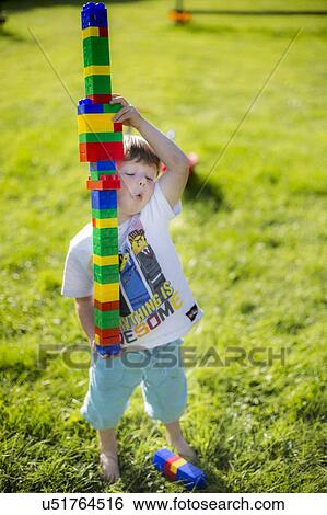 Stock Photograph - Boy playing with plastic bricks. Fotosearch