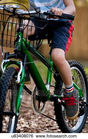 Boy riding bicycle View Large Photo Image Stock Photograph - Boy riding bicycle. Fotosearch
