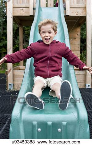Boy sliding down a slide View Large Photo Image Stock Photo - Boy sliding down a slide. Fotosearch