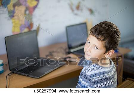 Picture - Boy using laptop. Fotosearch